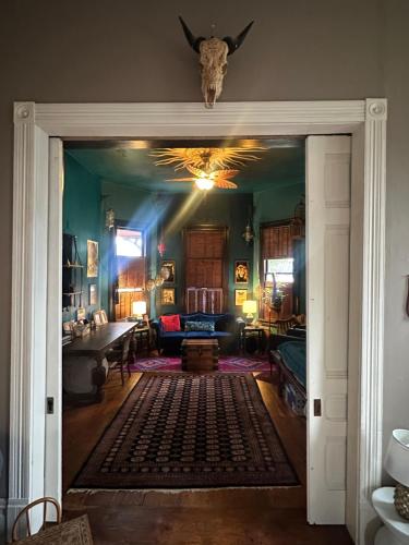 a door into a room with a living room at Charming Unique Themed Victorian Elegance in Eureka