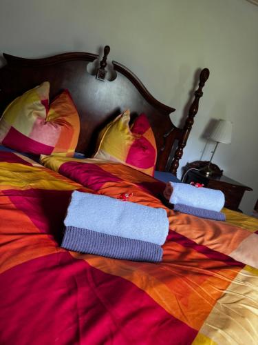 a bed with towels and pillows on it at Lužická bouda - penzion & hospůdka in Mařenice