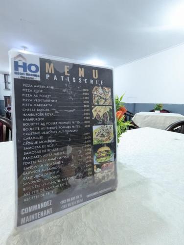 a sign sitting on top of a table at Hôtel ONANGA 