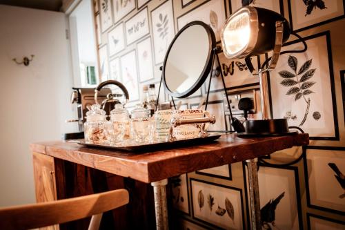 a dressing table with a mirror and a sink at The Queen's Head in Kingston upon Thames