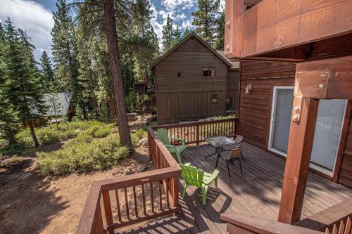 a deck with a table and chairs on a cabin at Tahoe Haven By Hauserman Rentals in Carnelian Bay