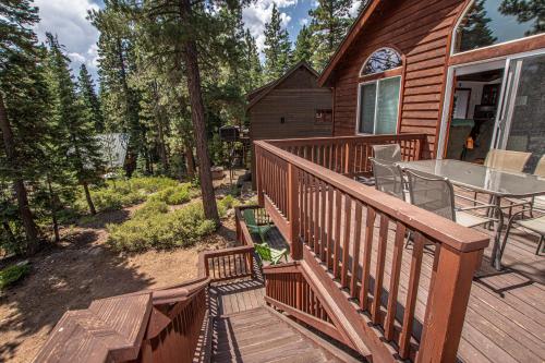 a wooden deck with a table on a house at Tahoe Haven By Hauserman Rentals in Carnelian Bay