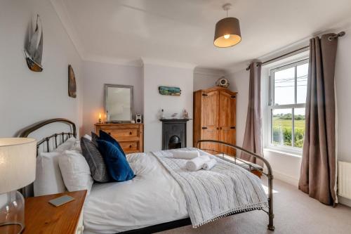a bedroom with a bed and a table and a window at Mill Cove in Wrentham