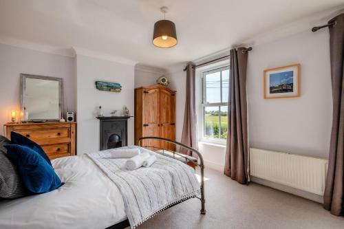a bedroom with a bed and a window at Mill Cove in Wrentham