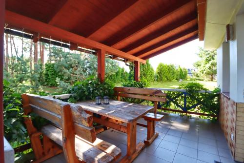un tavolo di legno e panche su un patio di Pas Edgarą 2 a Nida