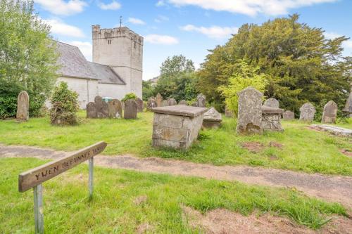 a cemetery with a sign in front of a church at 2 Bed in Defynnog oc-t32724 in Sennybridge