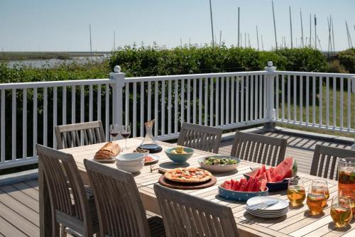 a wooden table with food and drinks on a deck at The Pavilion in Orford