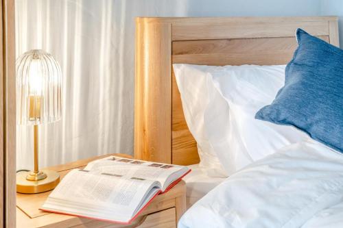 a book on a night stand next to a bed at 2 Bed in Defynnog oc-t32724 in Sennybridge