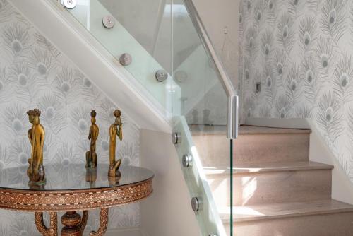 a stairway with a glass railing and a stair case at The Pavilion in Orford