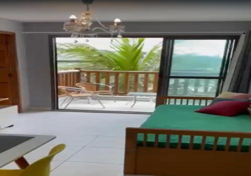 a bedroom with a bed and a view of the ocean at VG Sun Cumbuco - Praia e Tranquilidade in Caucaia