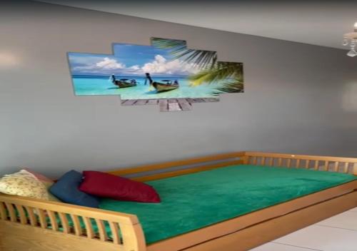 a bedroom with a bed with a painting on the wall at VG Sun Cumbuco - Praia e Tranquilidade in Caucaia