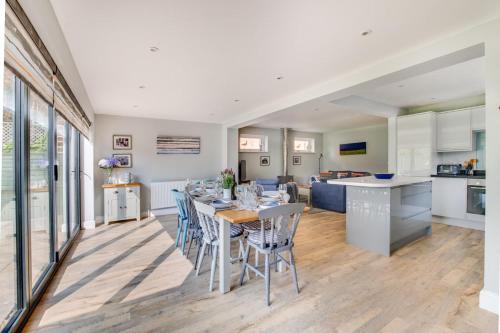 a kitchen and living room with a table and chairs at Loxwood in Reydon