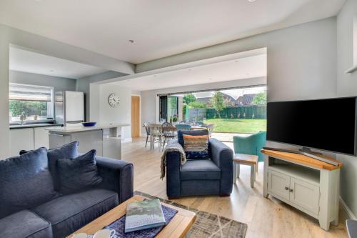 a living room with a couch and a tv at Loxwood in Reydon