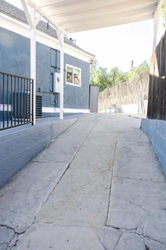 an empty sidewalk in front of a house at Mid Century Modern - Walk to Dodger Stadium, DTLA in Los Angeles
