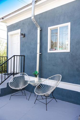 two chairs and a table on a patio at Mid Century Modern - Walk to Dodger Stadium, DTLA in Los Angeles