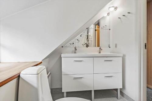 a white bathroom with a sink and a toilet at 2601-Romo-Praestekraven-7 in Mølby