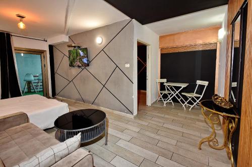 a room with a bed and a couch and a table at the royal lake views in Tiberias