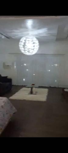 a bathroom with a sink and a light on the ceiling at Kim's Apartment in Takoradi