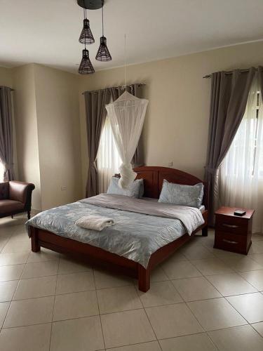 a bedroom with a large bed in a room at Mbibo Farmhouse in Mityana