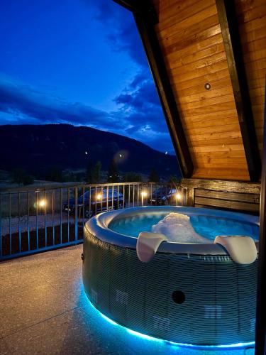 a hot tub on a balcony at night at Villa Merima Vlasic in Vlasic