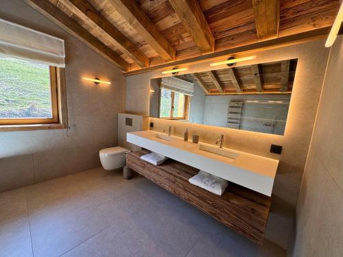a bathroom with a sink and a mirror at Chalet de Luxe pour 12 Pers. avec Sauna et Cinéma - FR-1-452-398 in Saint-Marcel