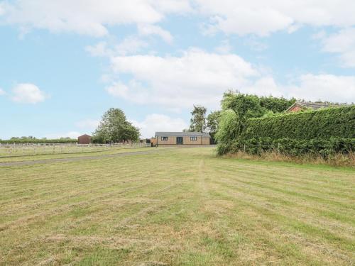 an open field with a building in the background at Fields View in Tamworth
