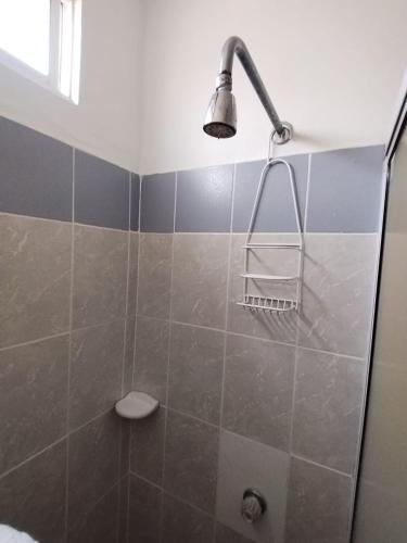 a bathroom with a shower with a light on it at Hotel De La Prada in Maicao