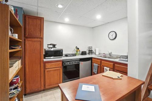 a kitchen with a stove and a sink and a table at 10 Mi to Dtwn Cozy Couples Getaway in Cincinnati in Cincinnati