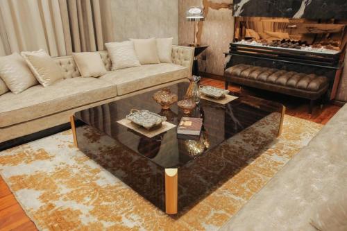 a living room with a couch and a coffee table at Holiday Inn islamabad in Islamabad
