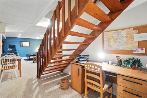 an office with a wooden desk and a staircase at 10 Mi to Dtwn Cozy Couples Getaway in Cincinnati in Cincinnati