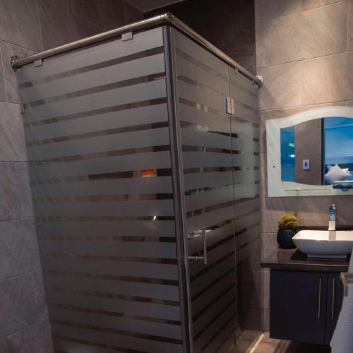 a bathroom with a shower and a sink at RED HEART 3 BEDROOMS OCEAN VILLAGe in Puerto Plata