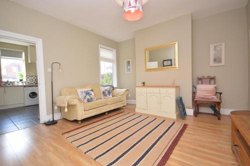 a living room with a couch and a chair at Wood lane Castleford in Featherstone