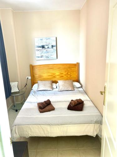 a bedroom with a bed with two towels on it at Beach front apartment with stunning ocean views! in Costa Calma
