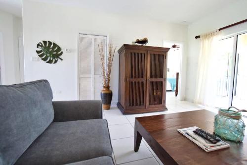a living room with a couch and a coffee table at 7 Up Condo at Kaibo Kai in Driftwood Village