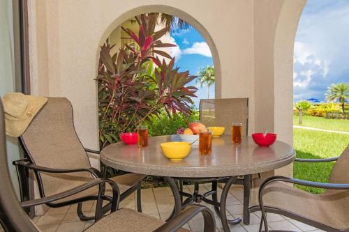 a table and chairs on a patio with a view at Georgetown Villas #113 in Seven Mile Beach
