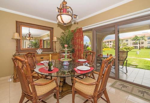 a dining room with a table and chairs at Georgetown Villas #113 in Seven Mile Beach