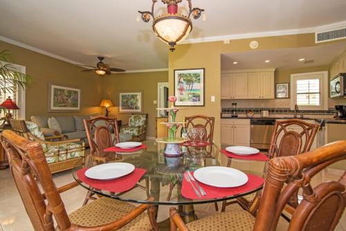 a kitchen and living room with a table and chairs at Georgetown Villas #113 in Seven Mile Beach