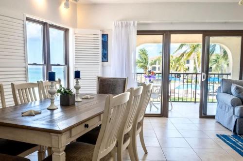 a dining room with a table and chairs and a couch at Georgetown Villas #218 in George Town