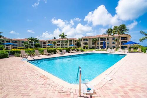 a pool at a resort with chairs and condos at Georgetown Villas #218 in George Town