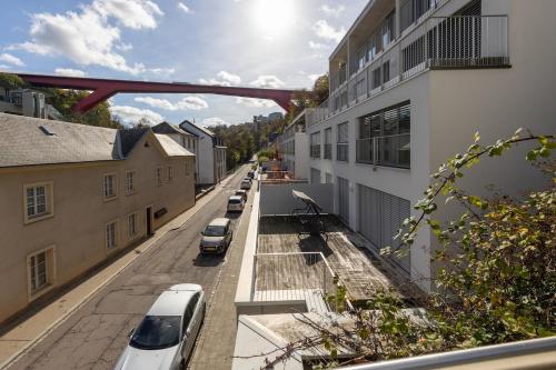 a street with cars parked on the side of a building at Cosy European Instituts in Luxembourg