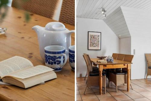 a room with a table and a book and a vase at 2008-Romo-Froidal-10 in Toftum