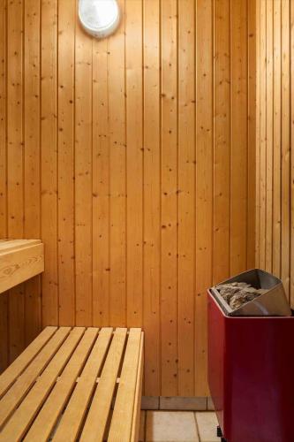a room with a wooden wall with a bench and a light at 2008-Romo-Froidal-10 in Toftum