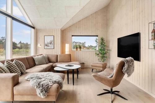 a living room with a couch and a tv at 2551-Romo-Chresten-Krommes-vej-5 in Tagholm