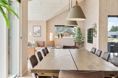 a dining room with a large wooden table and chairs at 2551-Romo-Chresten-Krommes-vej-5 in Tagholm