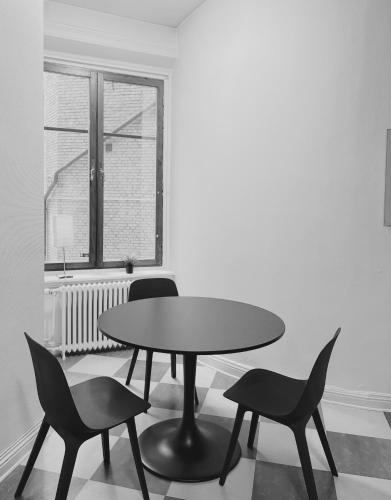 a table and chairs in a room with a window at Hotel Lemonade in Gothenburg