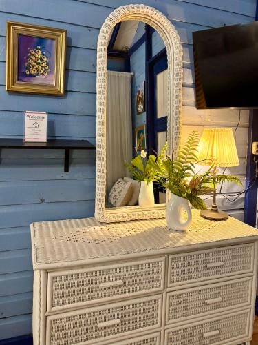 a wicker dresser with a mirror on top of it at Campito Loving in Higuey