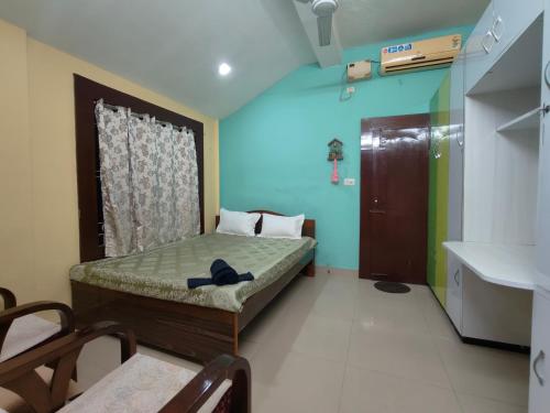 a small room with a bed and a sink at Aira homestay in Guwahati