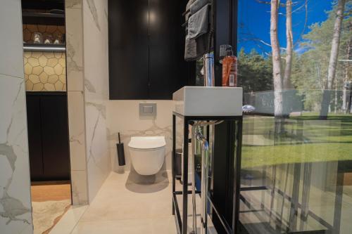 a bathroom with a toilet and a television in it at Tiny holiday complex in Kalana in Kalana