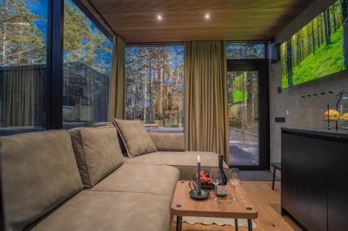 a living room with a couch and a tv at Tiny holiday complex in Kalana in Kalana