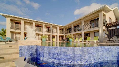 a swimming pool in front of a building at Seven Mile View Condo #4 in West Bay